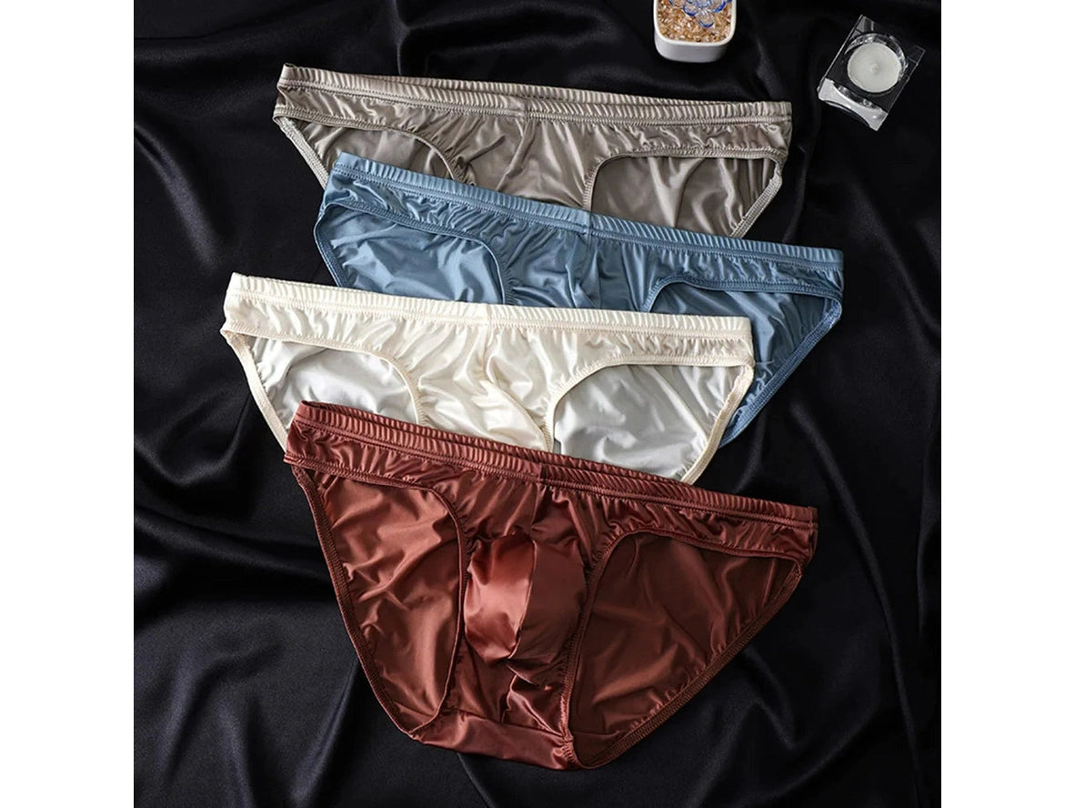 Four color Body Glide gay briefs flat lay on black satin fabric