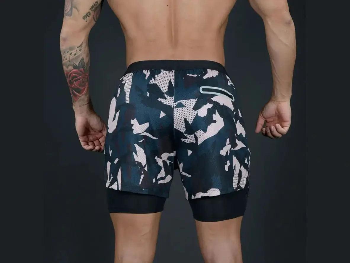 Muscular model wearing blue and black camo double-deck shorts
