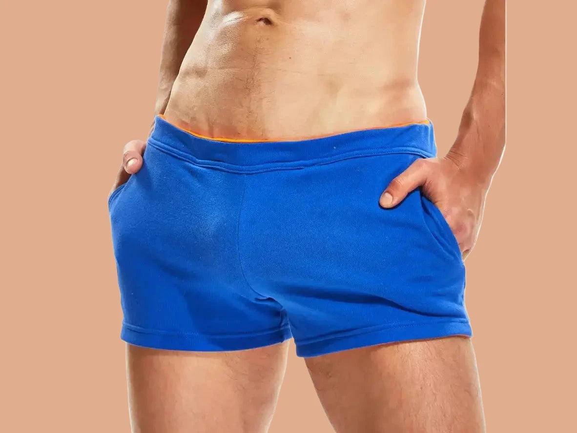 Royal blue gym shorts with orange waist trim and pockets front view