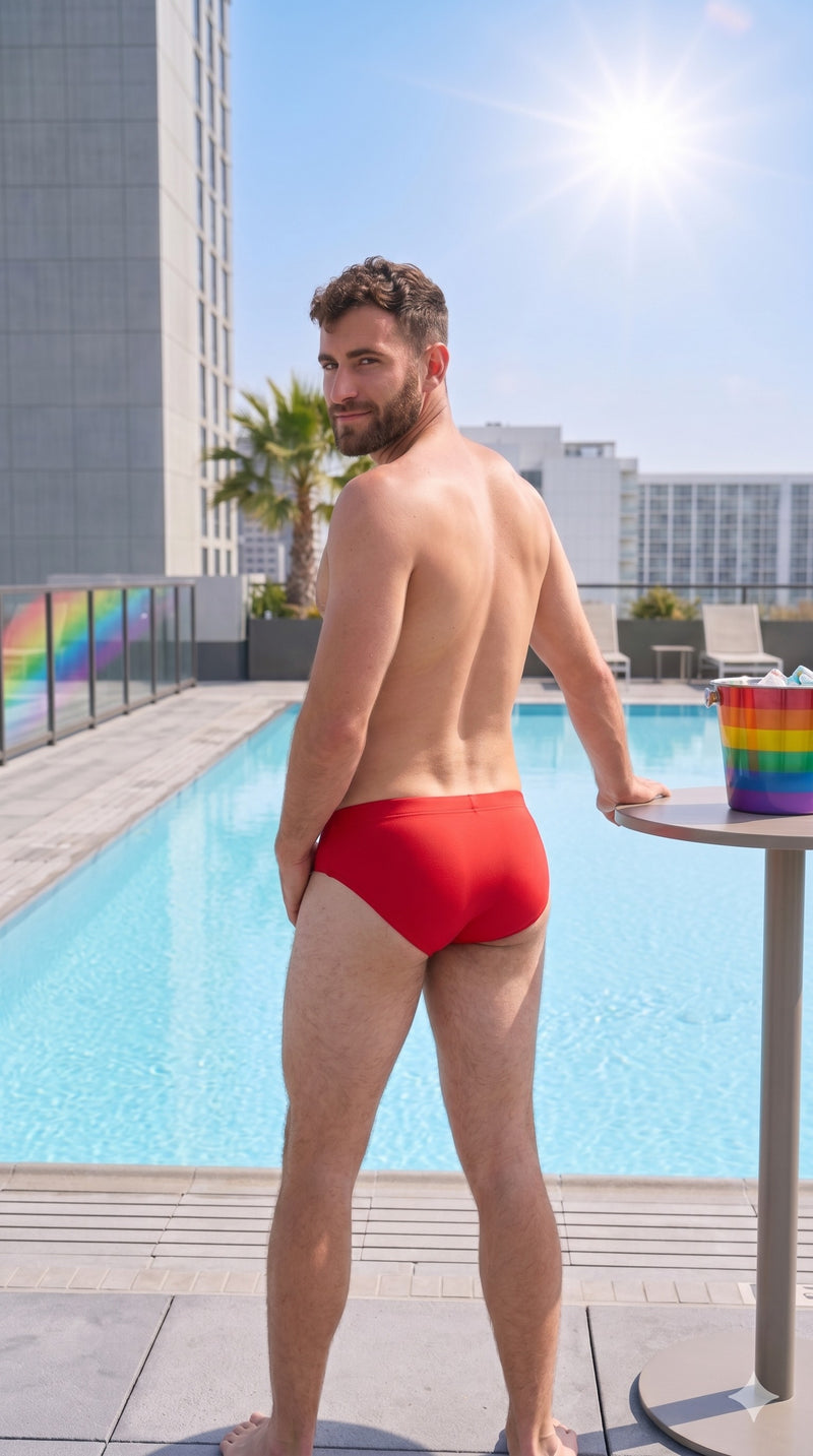 AI GENERATED IMAGE: Man in red swim trunks standing by a pool with a rainbow flag in the background