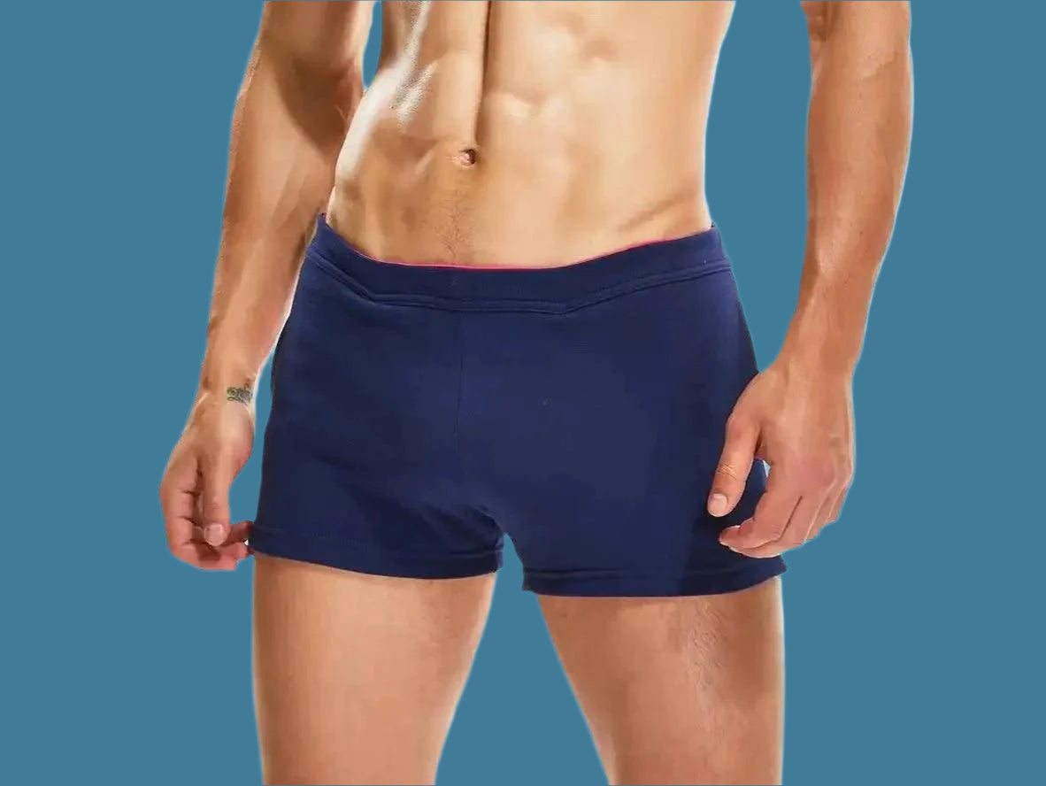 Navy blue gym shorts with pink inner waistband lining front view