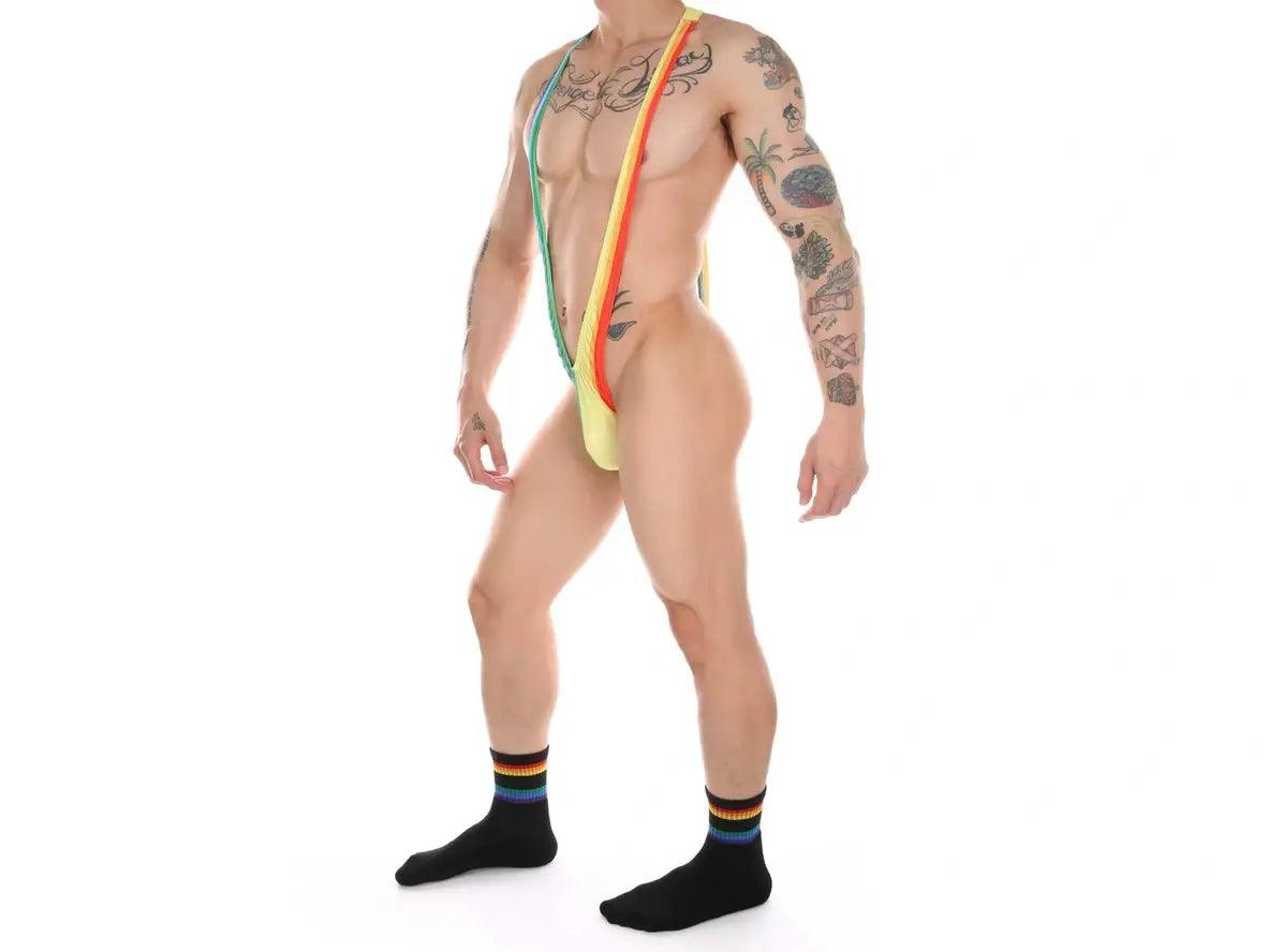 Side view of men's rainbow patchwork swimwear showing low-rise fit