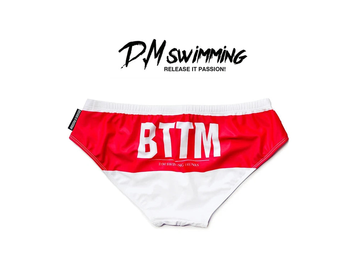 White D.M swim briefs red waistband BTTM text flat lay