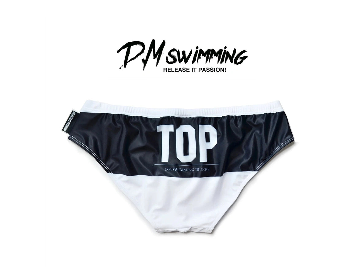 White D.M swim briefs flat lay black waistband TOP text detail