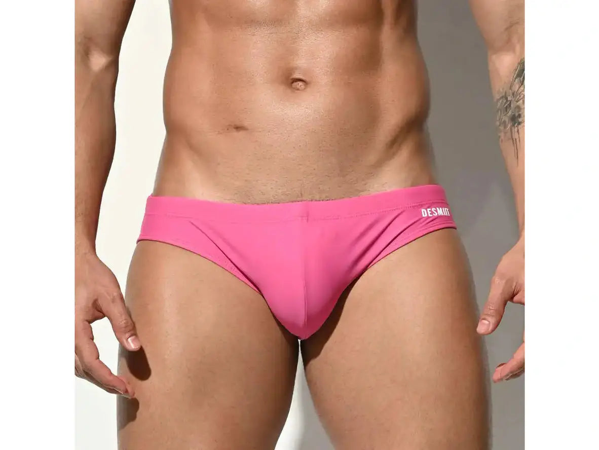 Vibrant pink low-rise men's swim briefs with DESMIIT waistband logo