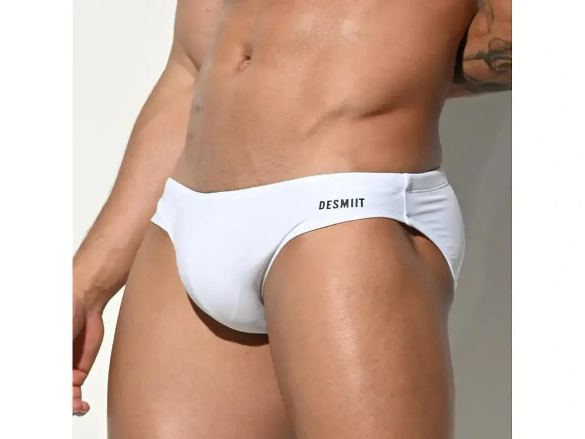 White seamless low-rise swim briefs with black DESMIIT logo side view