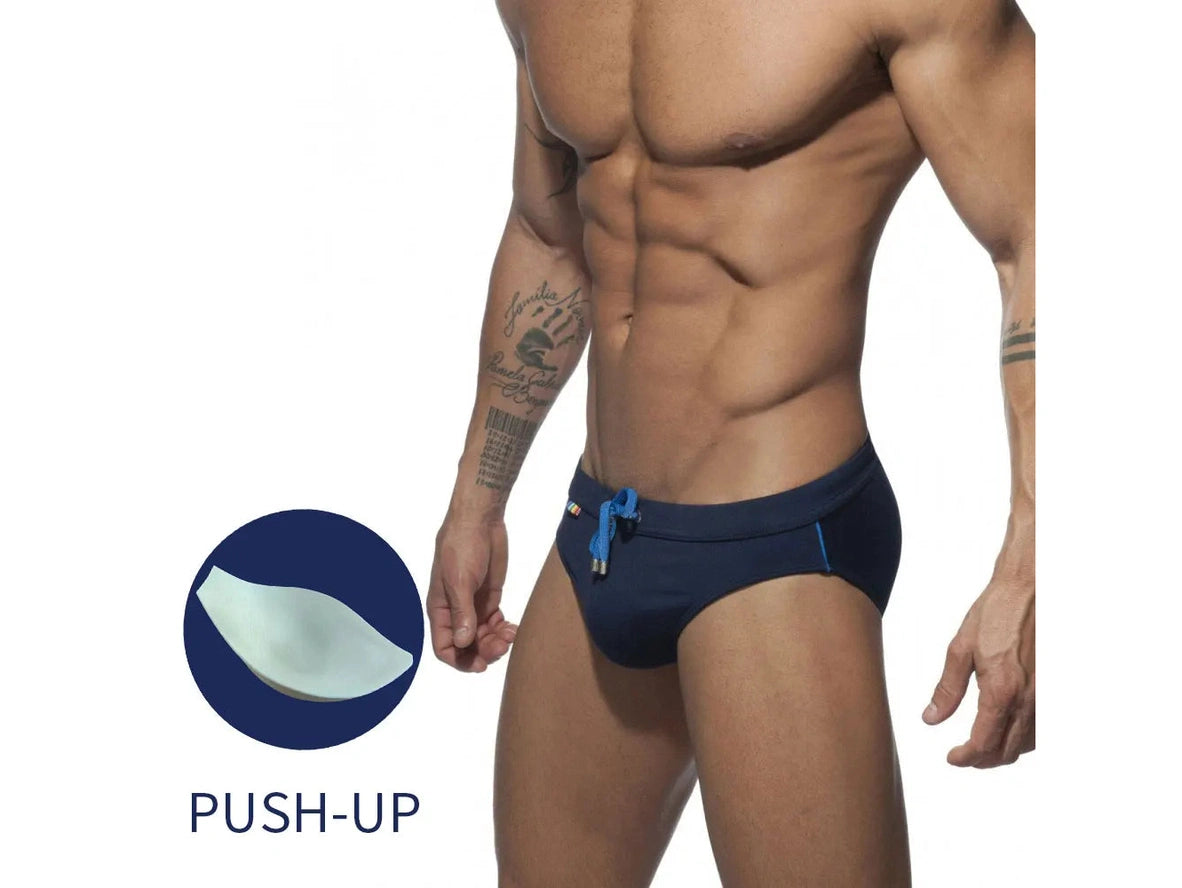 Navy blue swim briefs with inset graphic of push-up pad