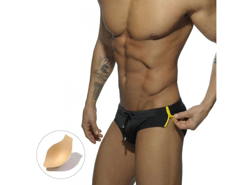 Black swim briefs with yellow zippers pulled to show side feature