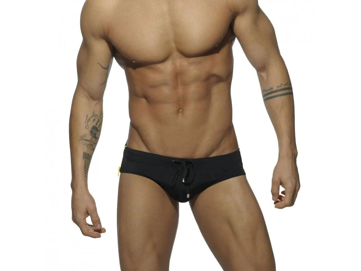 Full-frontal black swim briefs with yellow side zippers and drawstring
