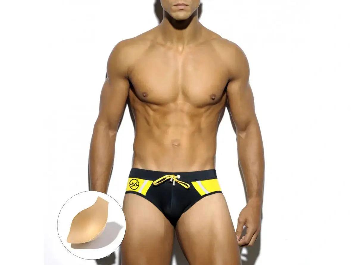 Black low-rise gay swim briefs with yellow side panels and removable chest pad