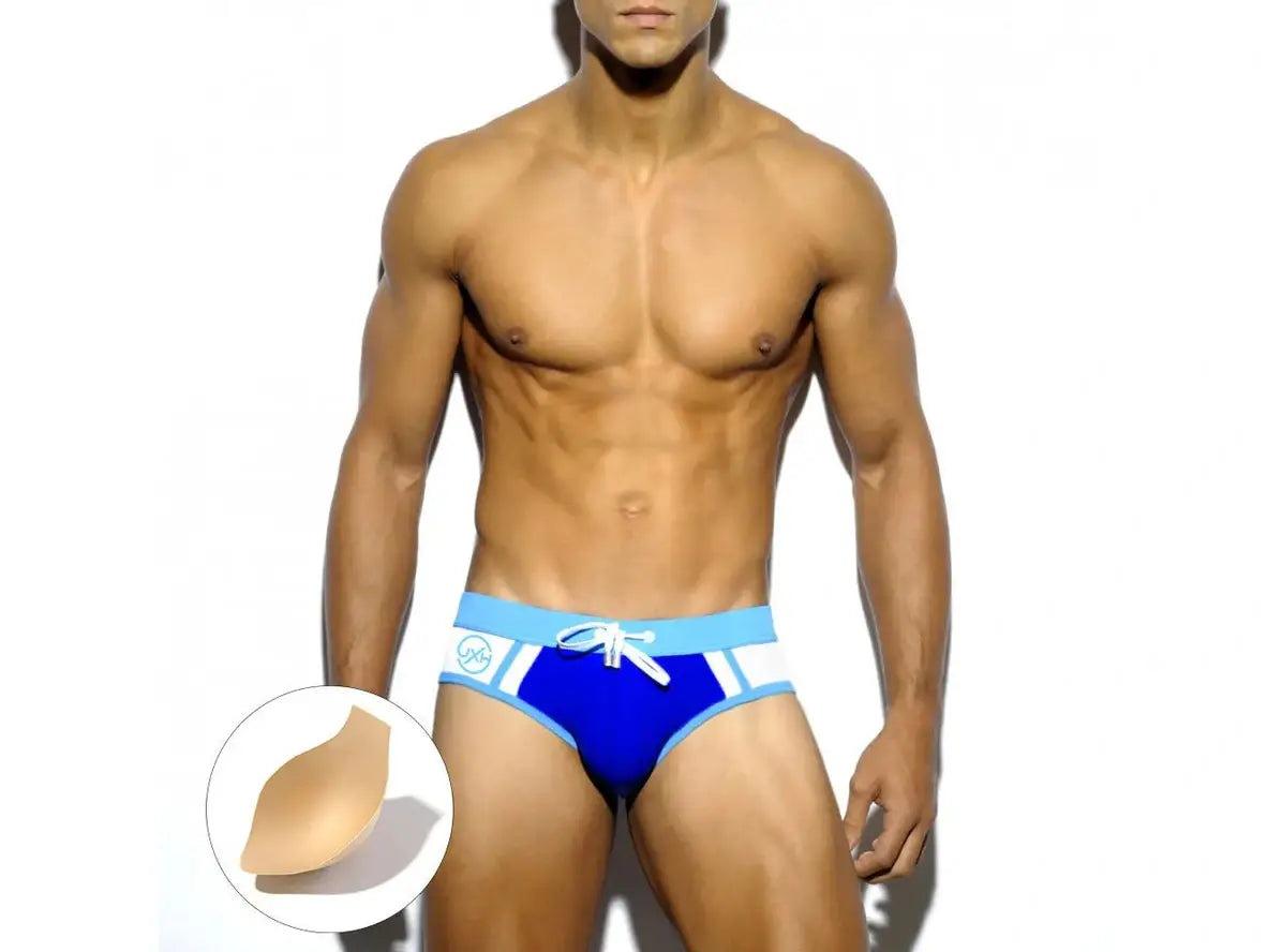 Blue low-rise gay swim briefs featuring white side stripes and adhesive chest liner