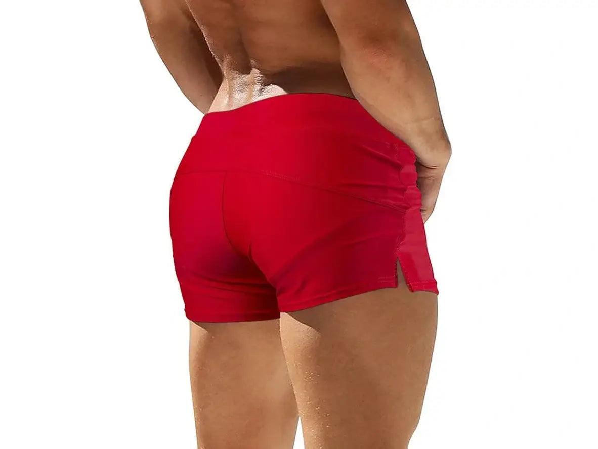 Red men's swim trunks featuring high-waisted back seams and side leg slit