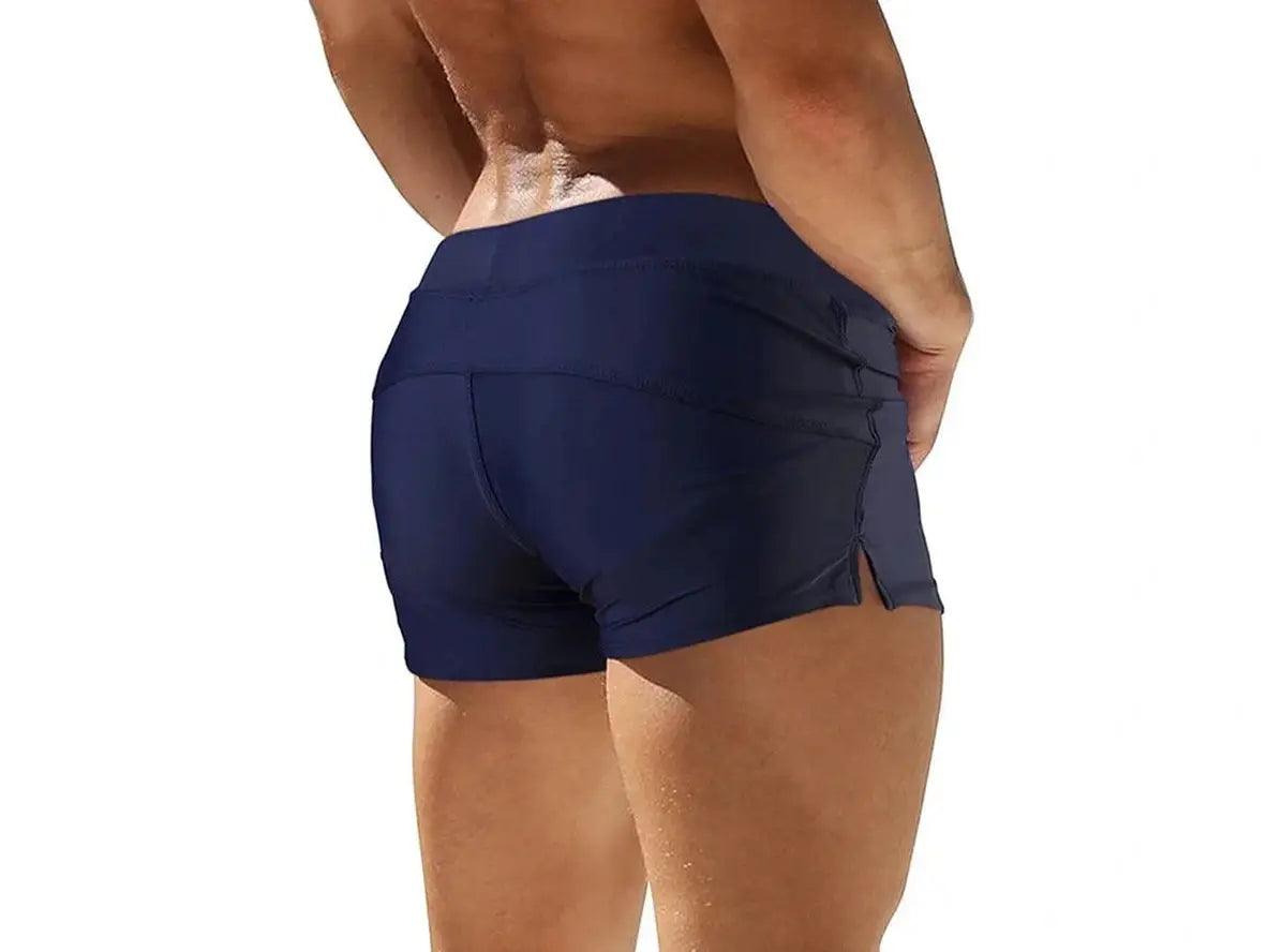 Dark navy low-rise men's swim trunks with smooth form-fitting back view