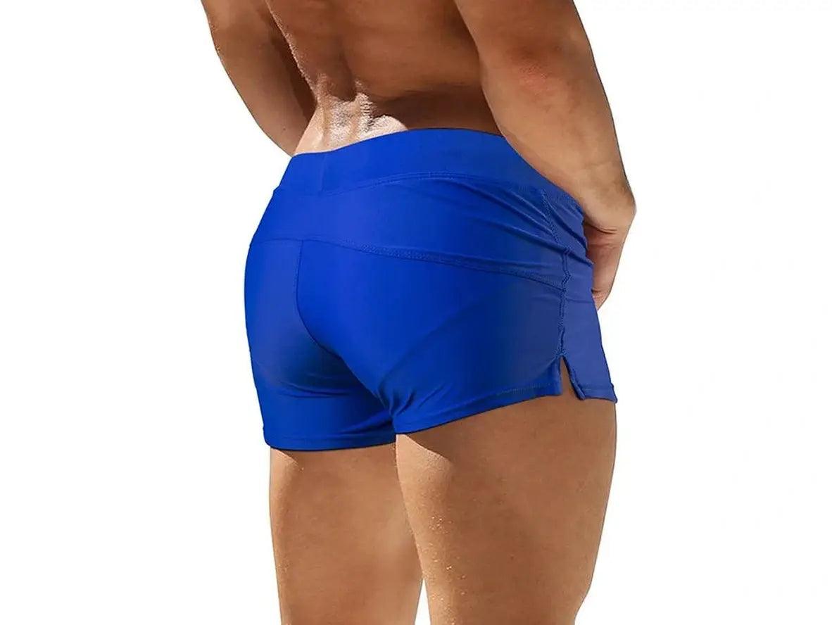 Royal blue low-rise men's swim trunks showing high-waisted back panel fit