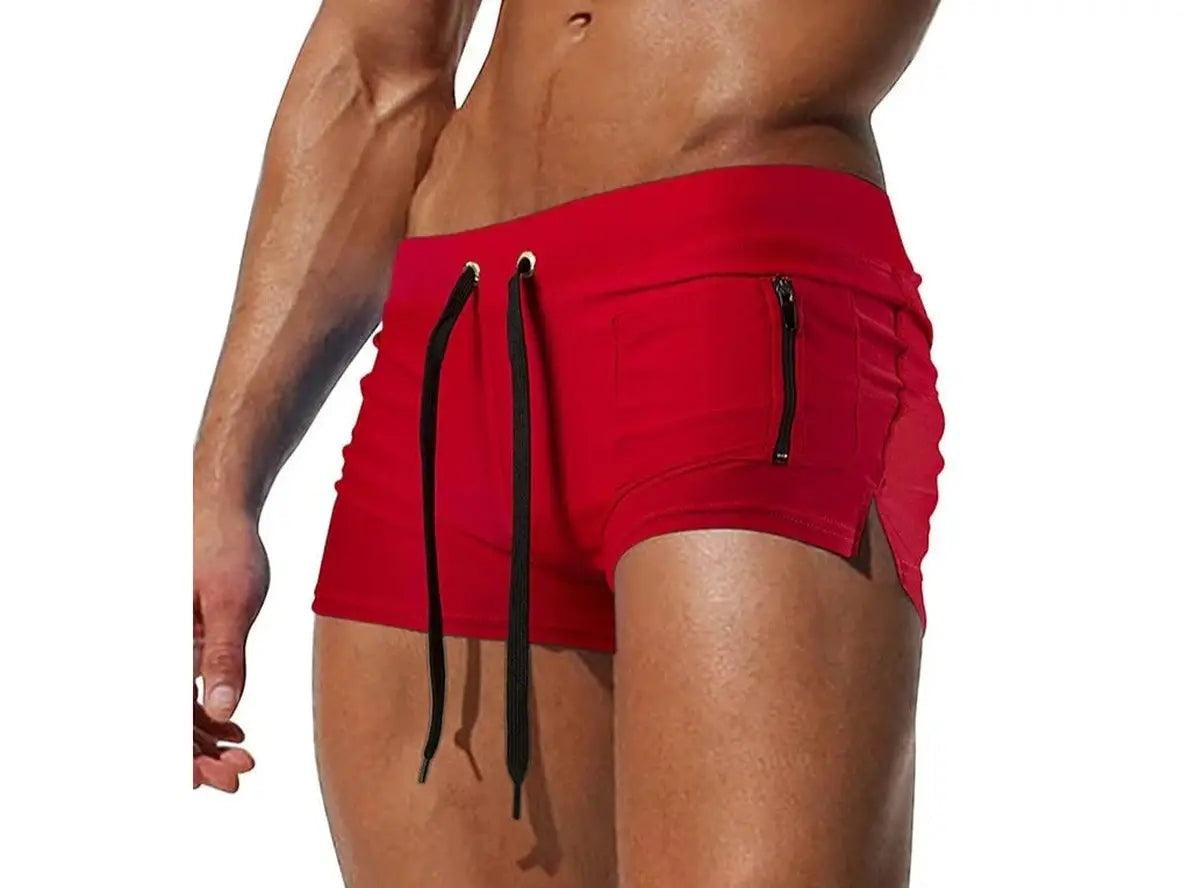 Vibrant red low-rise men's swim trunks featuring side zippered pocket