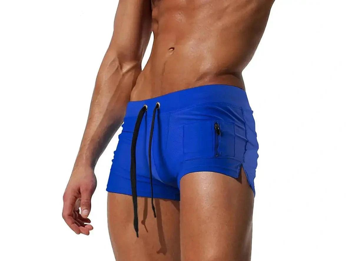 Bright blue men's swim trunks with metal eyelet drawstring and side slit