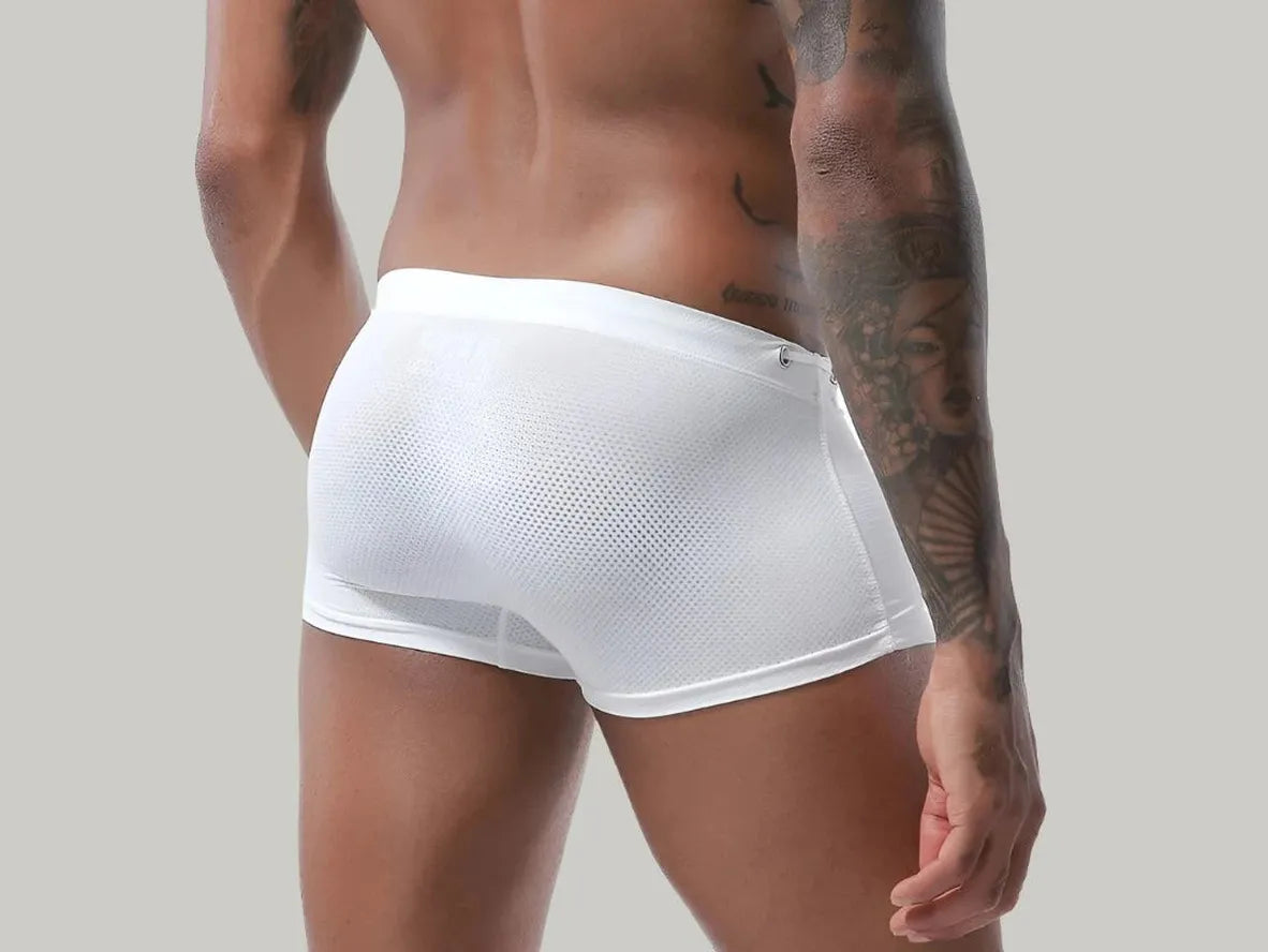 White low-rise men's swim trunks with perforated mesh rear panel detail