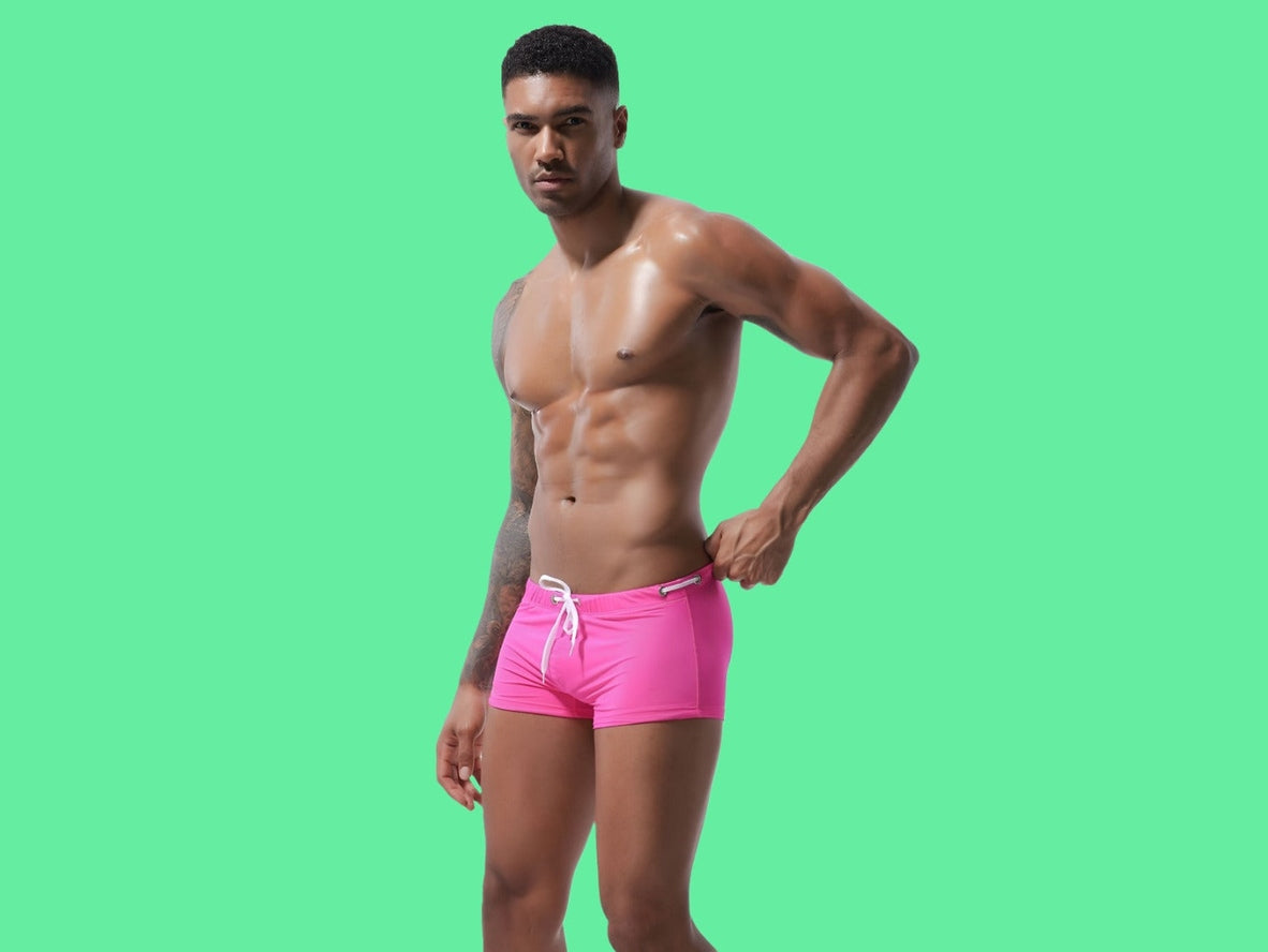 Fuchsia solid low-rise men's swim trunks with smooth seamless fabric