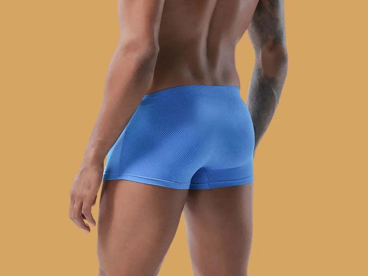Royal blue low-rise men's swim trunks with textured dot surface pattern