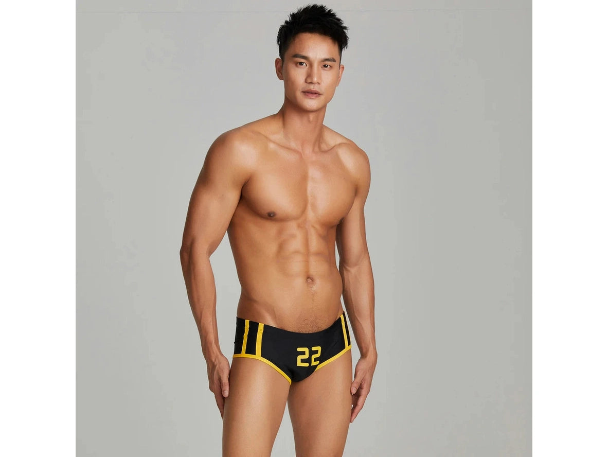 Black number 22 low-rise swim trunks with yellow stripes front view
