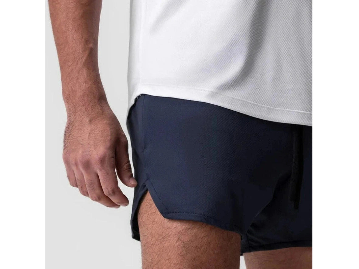Navy blue textured gym shorts close-up with side slit and stitching