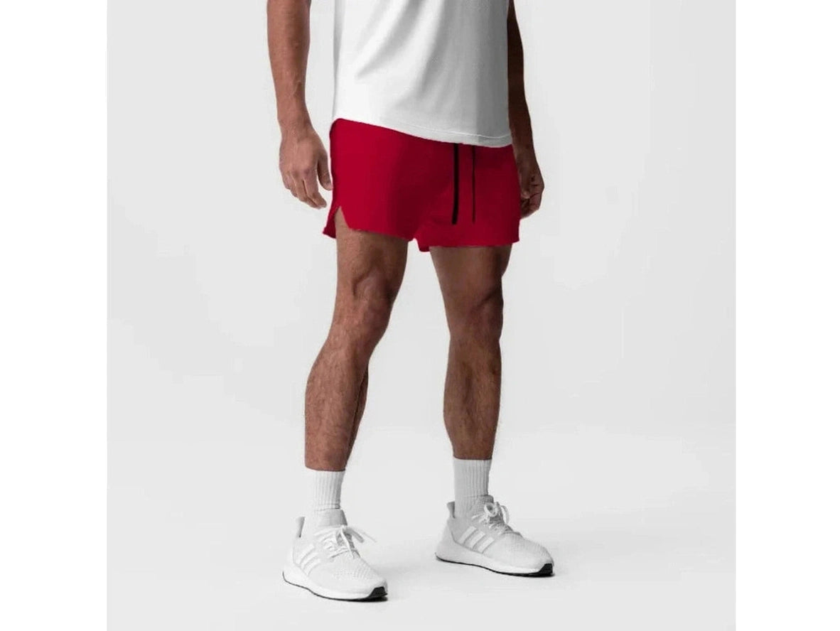 Red athletic shorts on model with mid-thigh length and stretchy fabric