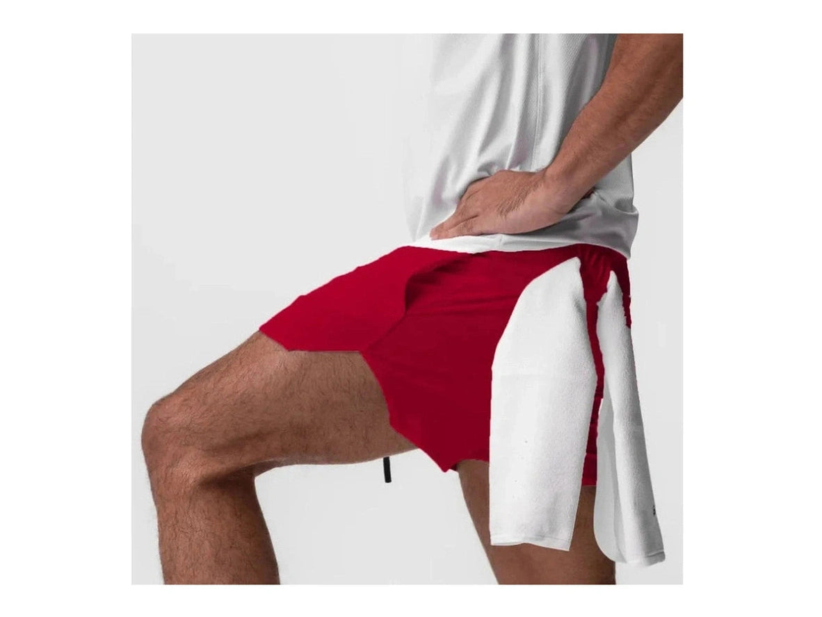 Red gym shorts on model leaning forward with mid-thigh fit
