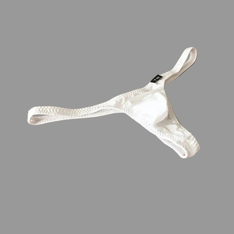 White thong on a beige fabric background with 'UNDER MOON' branding.