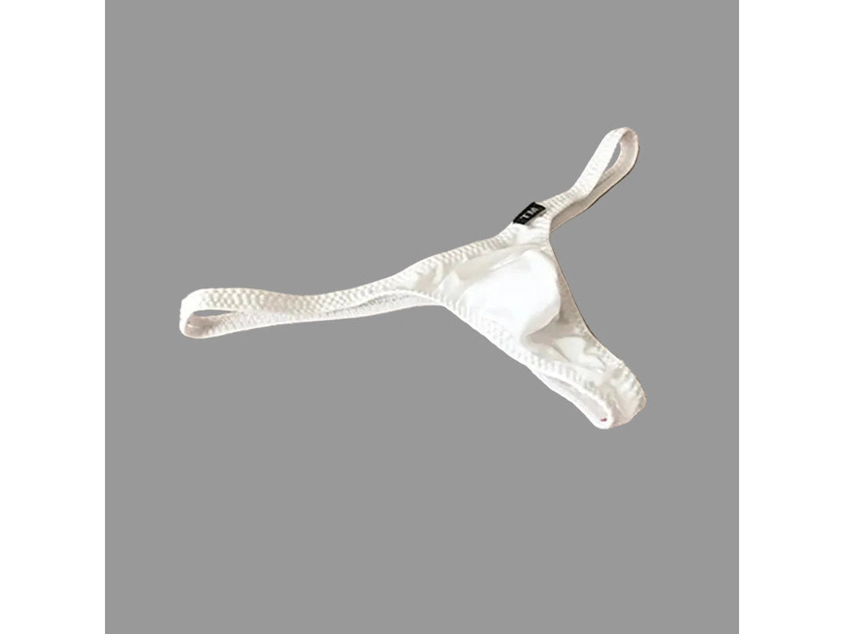 White thong on a beige fabric background with 'UNDER MOON' branding.