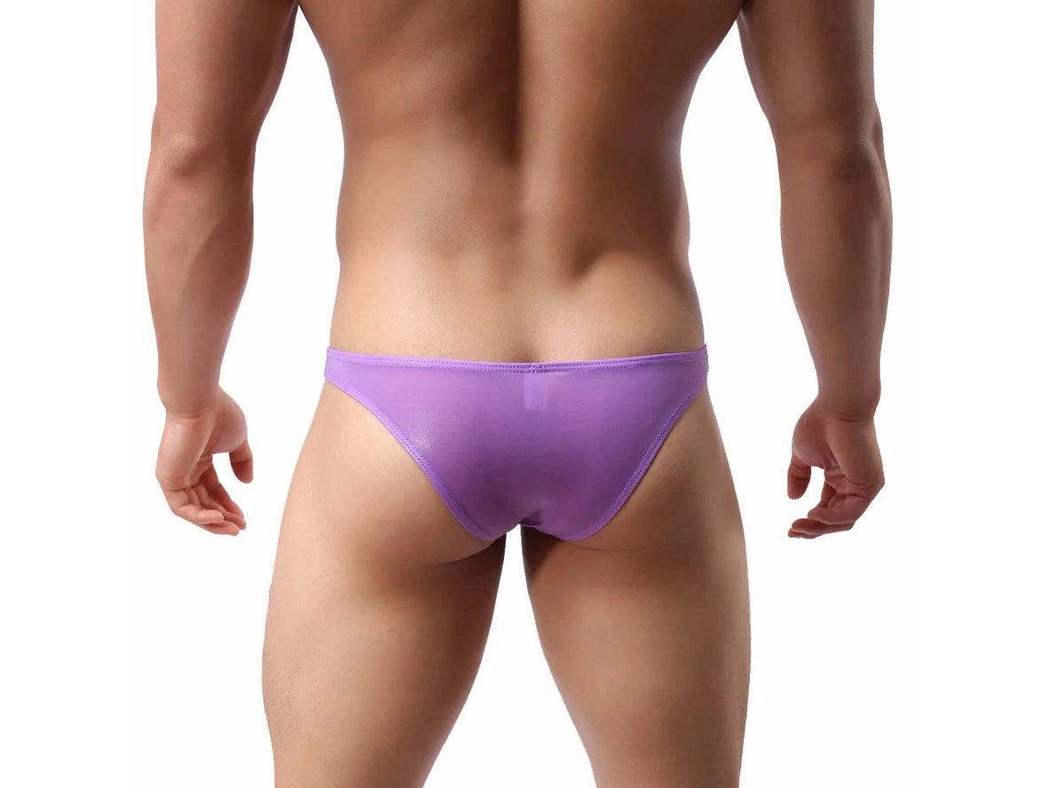 Muscular model wearing purple low-rise brief showing rear fit