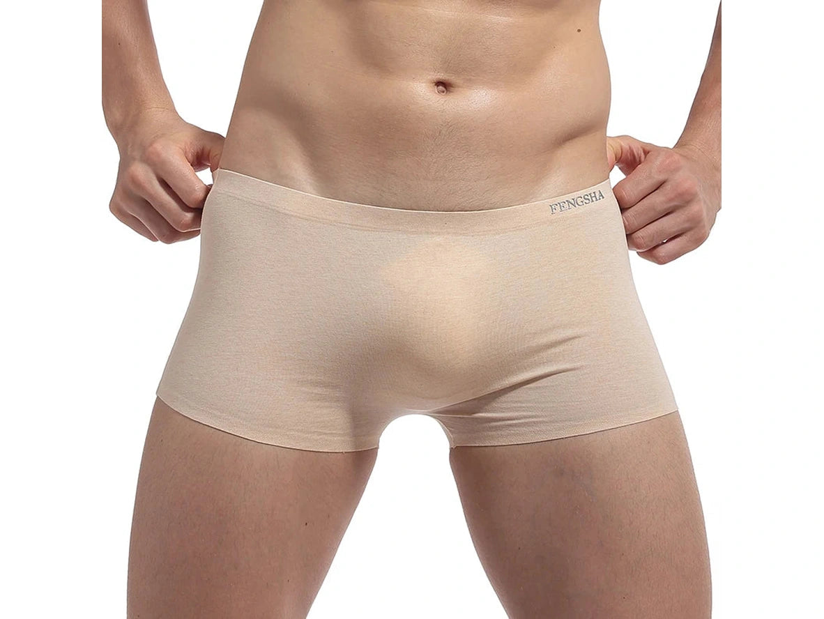 Beige seamless low-rise boxer briefs with model pulling waistband for fit