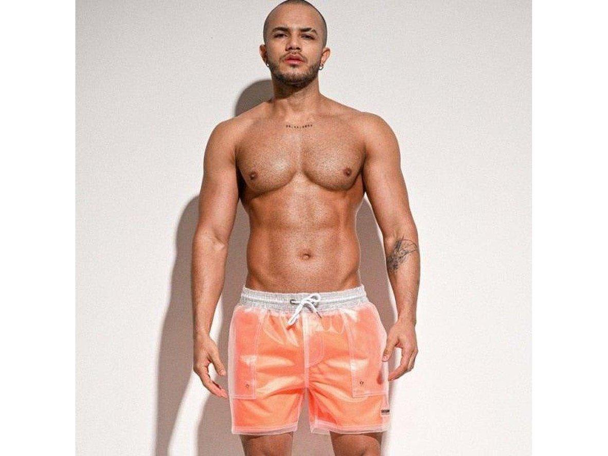Orange transparent men's swim trunks featuring white waistband and solid lining