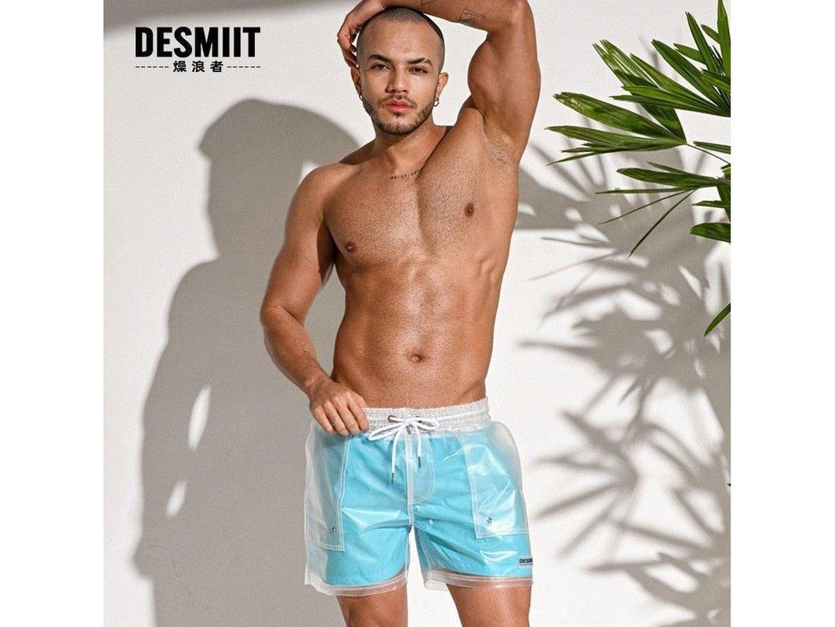 Light blue sheer swim shorts with 'DESMIIT' branding and palm leaf shadow