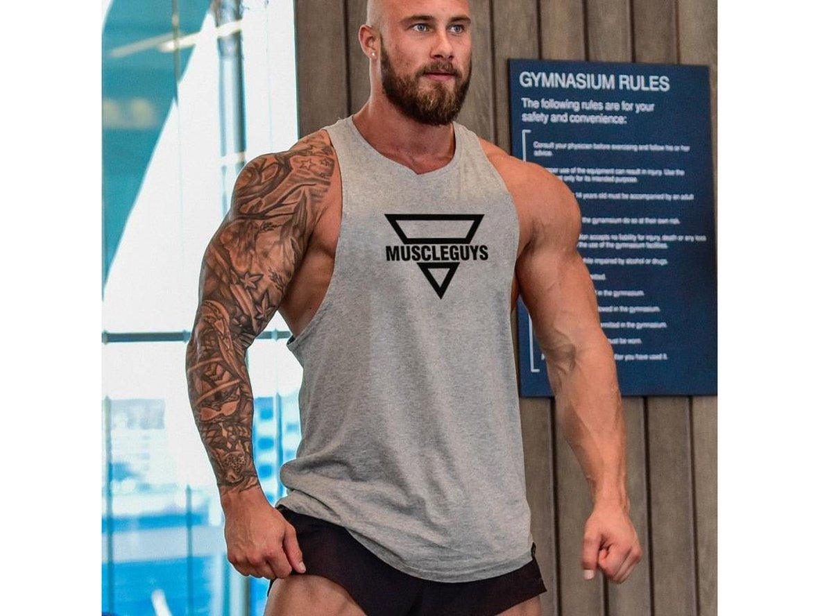 Men's heather gray tank top worn in gym with 'GYMNASIUM RULES' sign