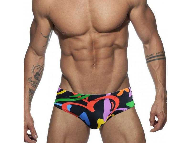 Low-rise black swim briefs with vibrant abstract print and beige push-up pad