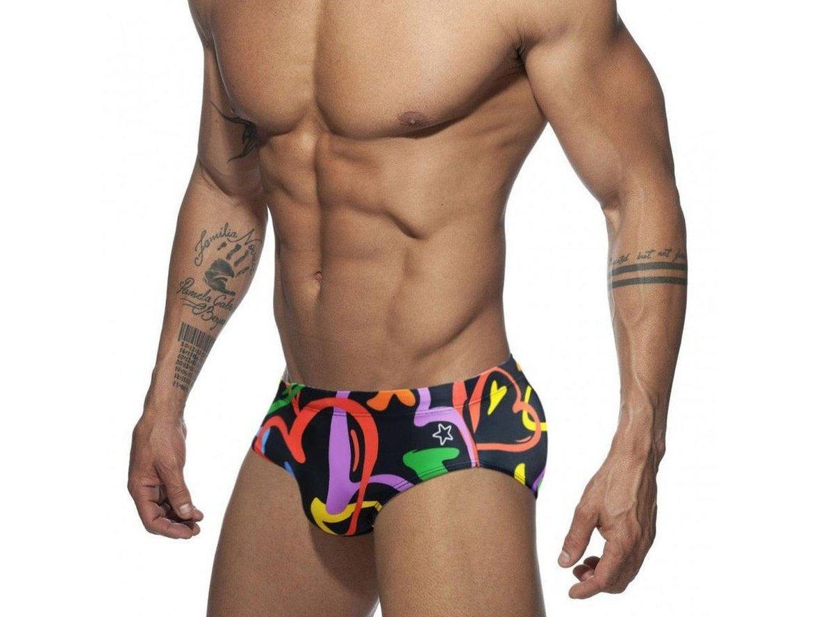 Men's low-rise black swim briefs with flowing rainbow shapes and small white star